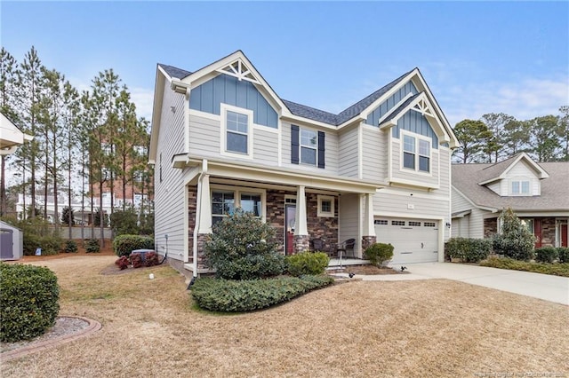 craftsman inspired home with a garage, covered porch, and a front lawn