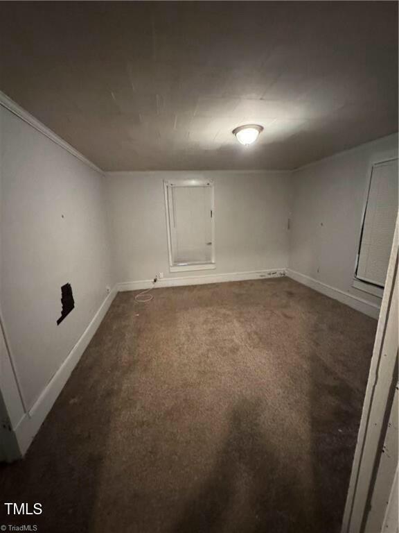 carpeted spare room with crown molding