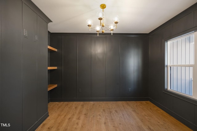 interior space featuring an inviting chandelier, a healthy amount of sunlight, and light wood-type flooring