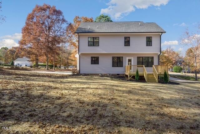 back of house with a wooden deck and a yard