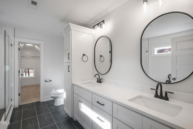 bathroom featuring tile patterned floors, plenty of natural light, toilet, and vanity