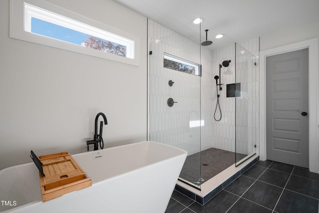 bathroom with tile patterned floors and shower with separate bathtub