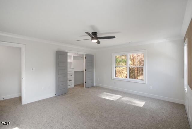 unfurnished bedroom featuring ornamental molding, light carpet, and ceiling fan