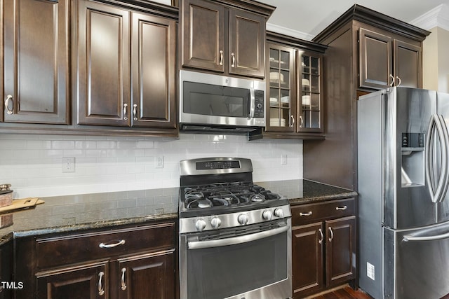 kitchen with tasteful backsplash, dark brown cabinetry, stainless steel appliances, and dark stone counters