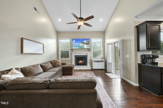 living room with ceiling fan, dark hardwood / wood-style floors, and high vaulted ceiling