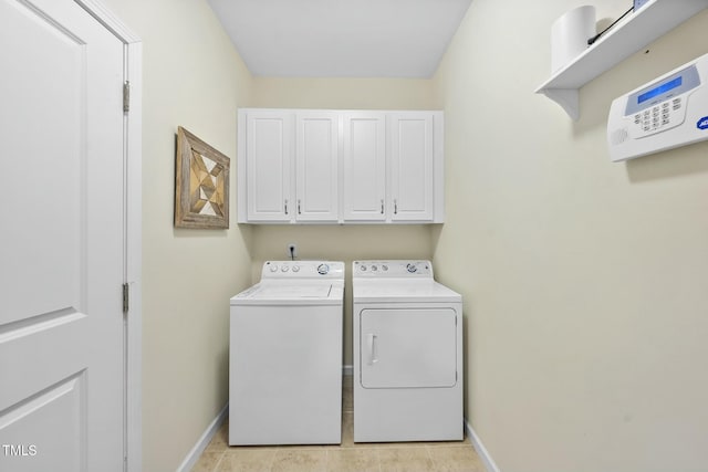 washroom featuring cabinets and washer and dryer