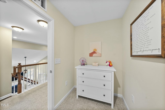 corridor featuring light colored carpet