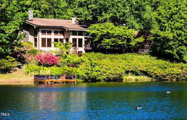 rear view of property with a water view