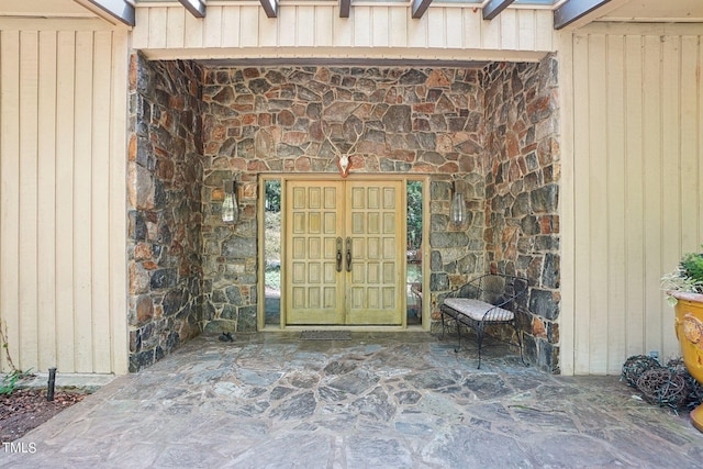 property entrance with a patio area and french doors