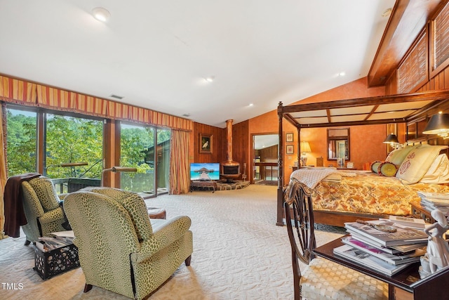 carpeted bedroom with wood walls, multiple windows, and lofted ceiling with beams