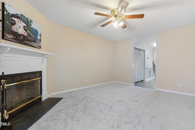 carpeted living room with a textured ceiling and ceiling fan