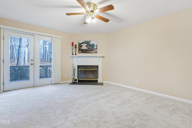 unfurnished living room featuring ceiling fan and light colored carpet