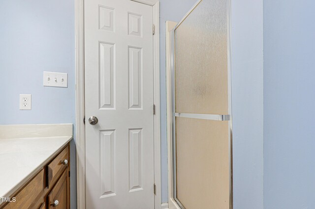 bathroom with vanity and an enclosed shower