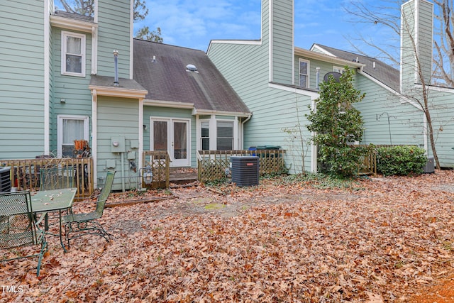 rear view of property with central AC unit and french doors