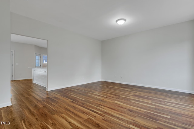 spare room with dark hardwood / wood-style floors