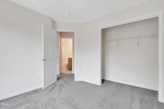 unfurnished bedroom with a closet and light carpet