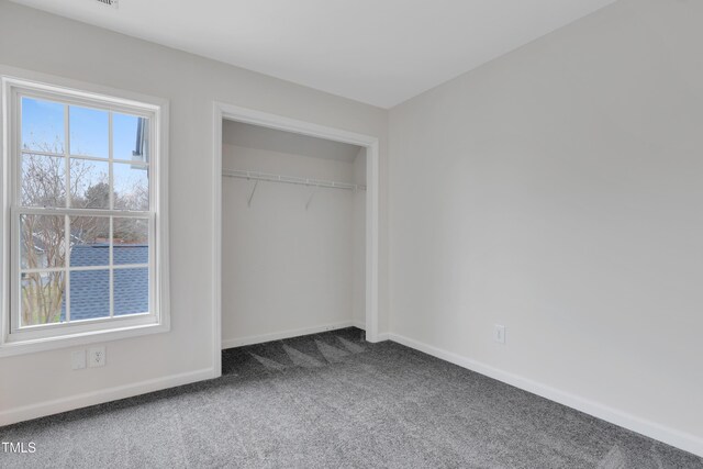 unfurnished bedroom featuring a closet and carpet