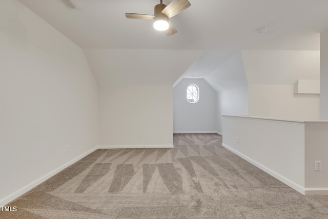 additional living space featuring lofted ceiling, light colored carpet, and ceiling fan