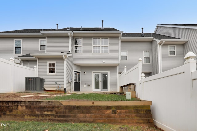 rear view of property featuring cooling unit and french doors