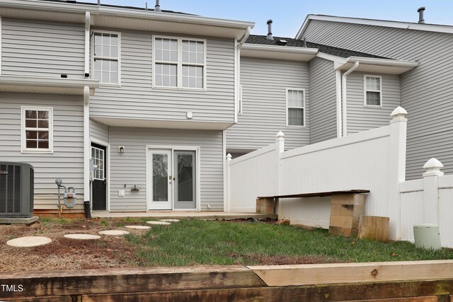 rear view of property with central AC