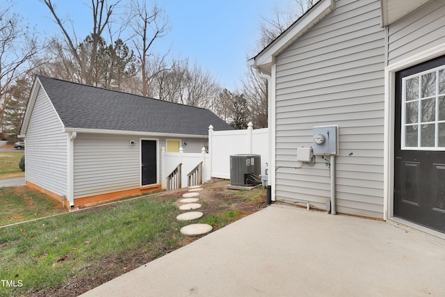 exterior space with a patio, central AC, and a lawn