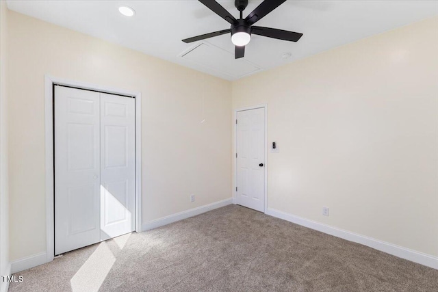 unfurnished bedroom featuring light carpet, ceiling fan, and a closet