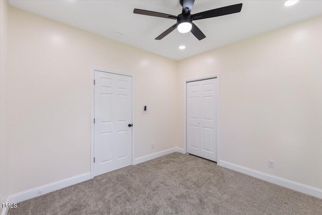 empty room with light colored carpet and ceiling fan