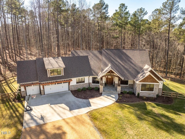 craftsman inspired home featuring a garage and a front yard