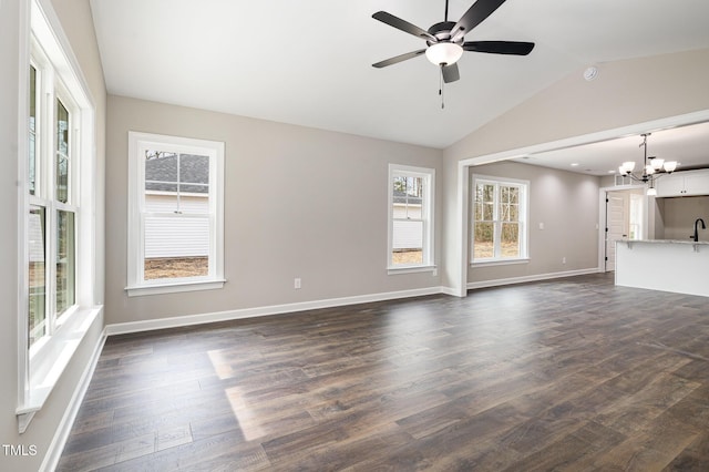 unfurnished living room with lofted ceiling, sink, ceiling fan with notable chandelier, and dark wood-type flooring