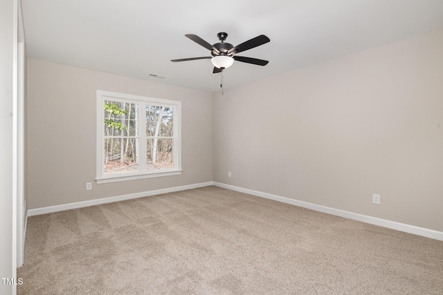 carpeted spare room with ceiling fan