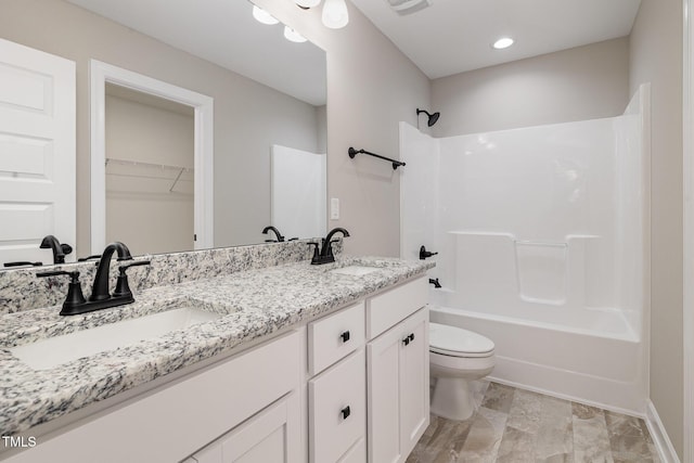 full bathroom featuring shower / bathtub combination, vanity, and toilet