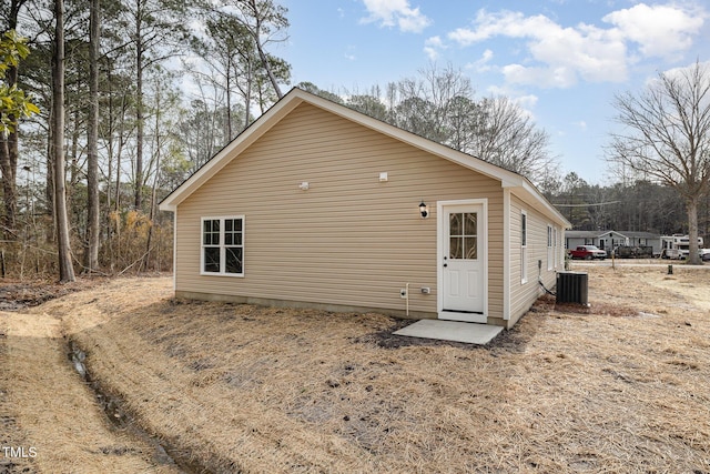 rear view of property featuring central AC