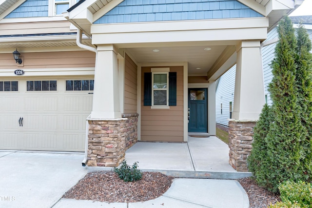 doorway to property featuring a garage and covered porch