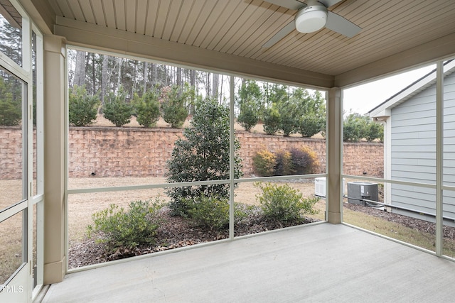 unfurnished sunroom with ceiling fan