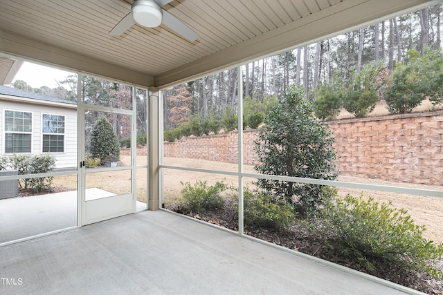 unfurnished sunroom featuring ceiling fan