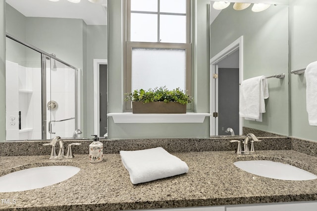 bathroom featuring vanity and an enclosed shower