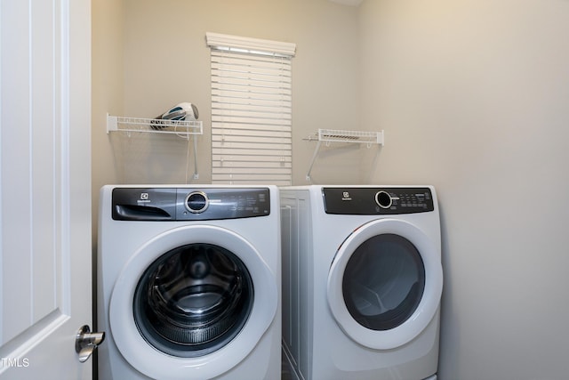 laundry room featuring washing machine and clothes dryer