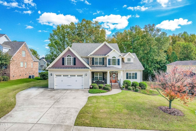 view of front of home with a garage, a front yard, and covered porch