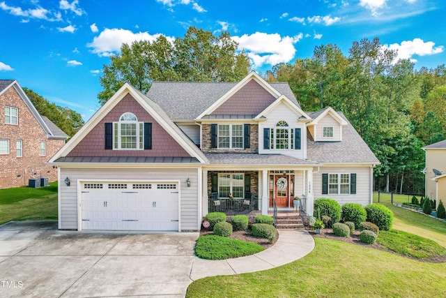 craftsman-style house featuring a garage, a front yard, and covered porch