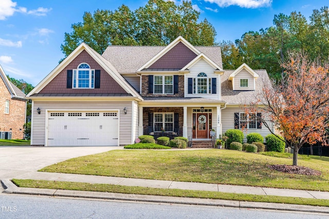 craftsman-style home with a garage, a front lawn, and a porch