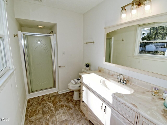 bathroom featuring vanity, toilet, and walk in shower