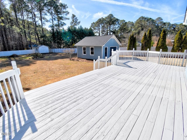 wooden deck with a lawn and a storage shed