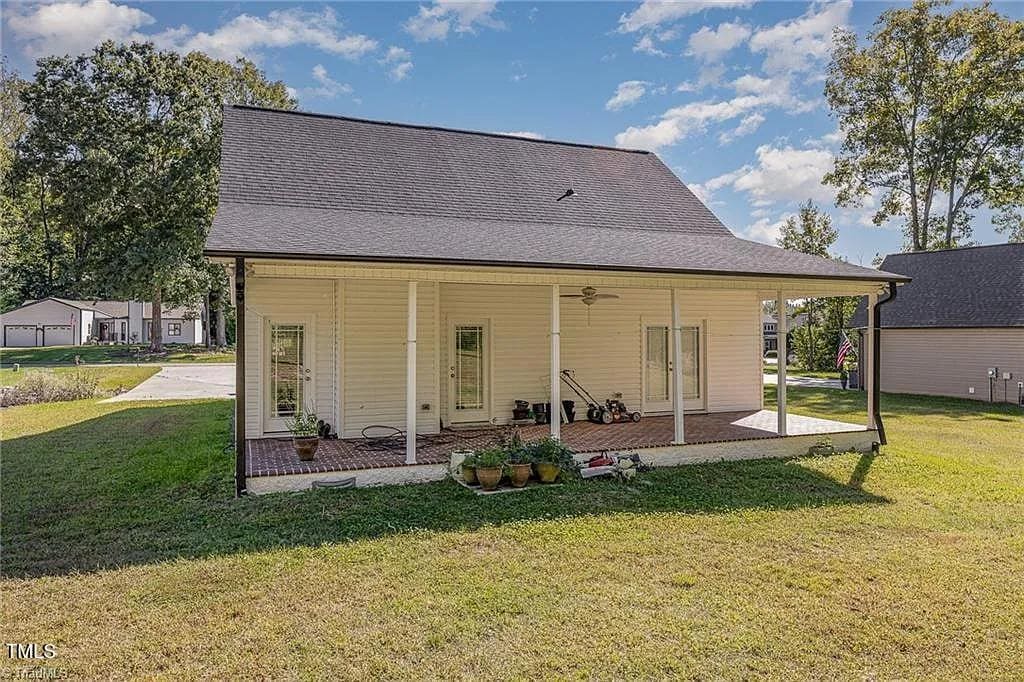 rear view of house featuring a yard