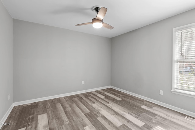 empty room with ceiling fan and light wood-type flooring