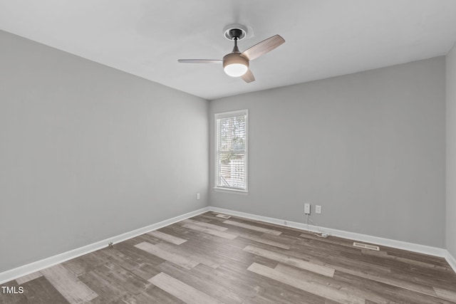 empty room with hardwood / wood-style flooring and ceiling fan