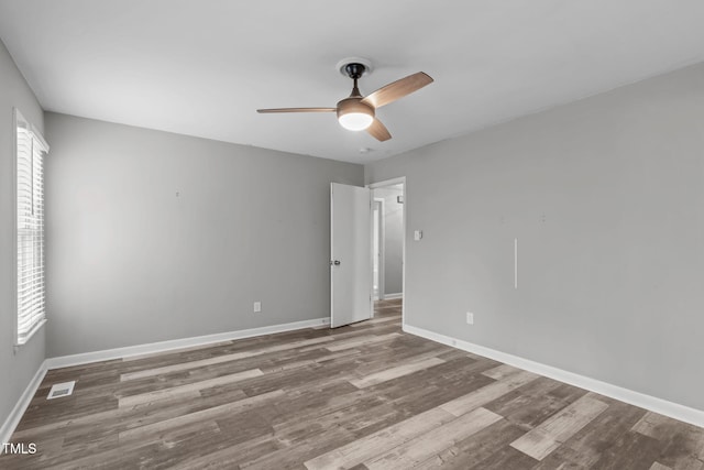 empty room featuring hardwood / wood-style flooring and ceiling fan