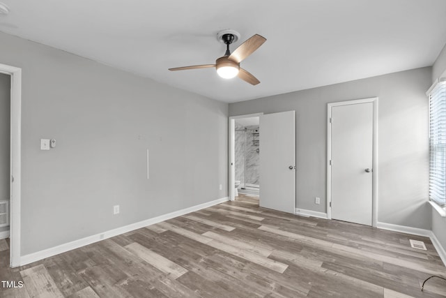 unfurnished bedroom featuring light hardwood / wood-style flooring, connected bathroom, and ceiling fan