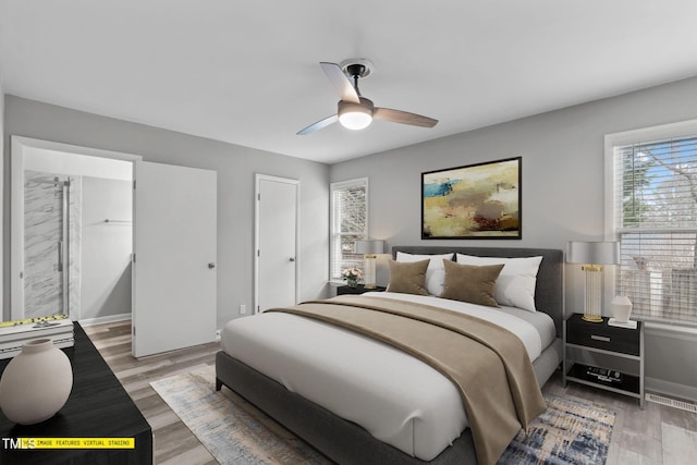 bedroom with ceiling fan and light hardwood / wood-style floors