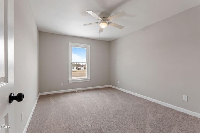 spare room featuring ceiling fan and carpet floors