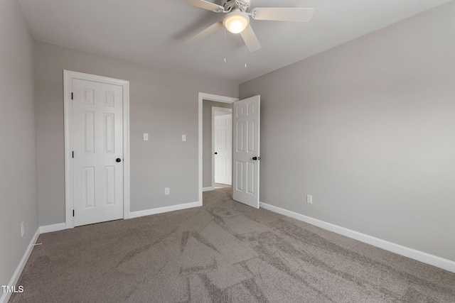 unfurnished bedroom featuring ceiling fan, a closet, and light carpet